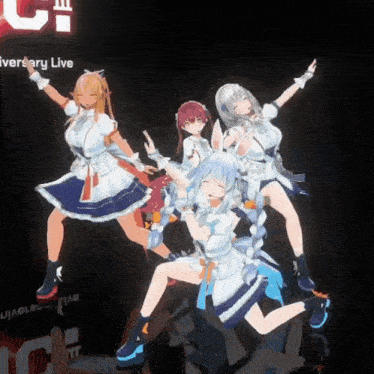 a group of anime girls are dancing on a stage in front of a sign that says anniversary live