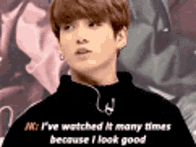 a young man is standing in front of a crowd and talking about watching it many times because i look good .