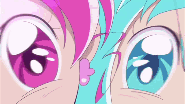 a close up of a girl 's eyes with pink and blue hair