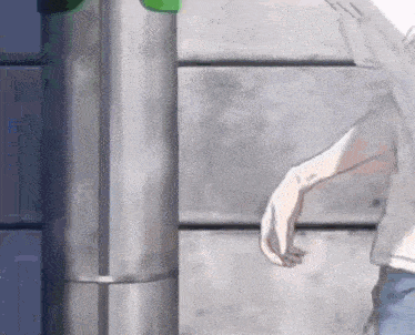 a person is standing next to a pole with a green light on it .