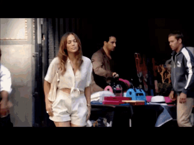 a man in a puma jacket stands next to a woman in a white top