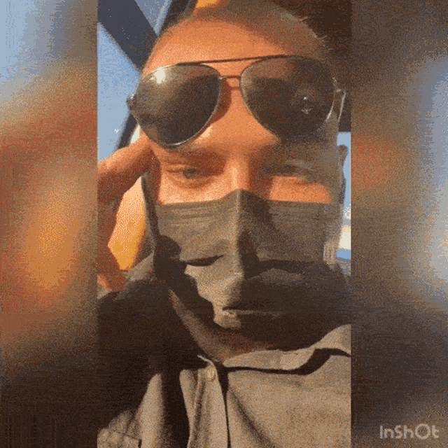 a man wearing sunglasses and a face mask is sitting in a car ..