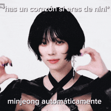 a woman making a heart shape with her hands and the words minjeong automaticamente