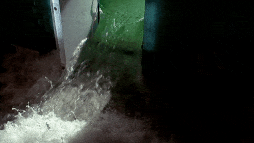 the water is coming out of a green door