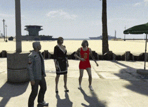 a man and two women are standing on a beach with a man wearing a red shirt that says ' basketball '