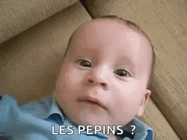 a baby is making a funny face while laying on a couch and saying `` les pepins '' .