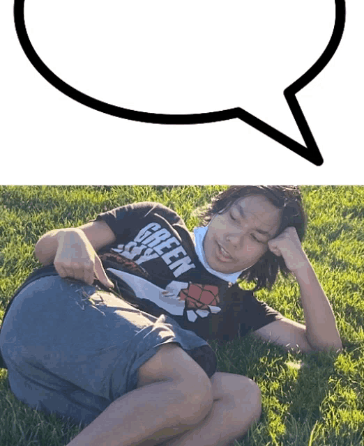 a person wearing a green sky shirt is laying on the grass