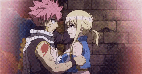 a man and a woman are hugging each other in a fairy tail anime .