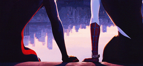 a couple of spiderman standing next to each other