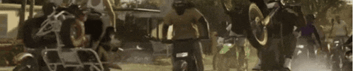 a blurry picture of a group of people riding bikes in a park .