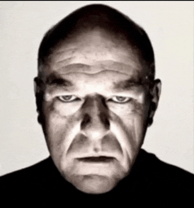 a close up of a man 's face with a serious look on his face
