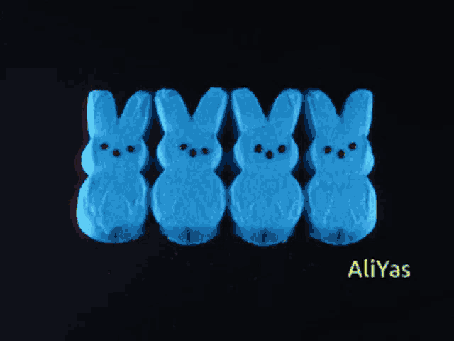 a row of yellow peeps bunnies are lined up on a black background