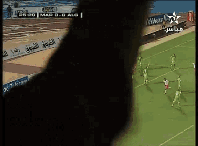 a soccer game is being played in a stadium with advertisements for pelikan and groupe ocp