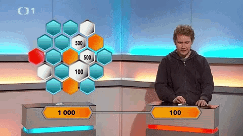 a man is playing a game with a grid of hexagons with the number 500 on it
