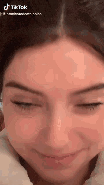 a close up of a woman 's face with her eyes closed and a caption that says tiktok