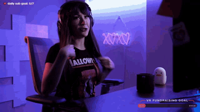 a woman wearing headphones and a t-shirt that says hallowin on it