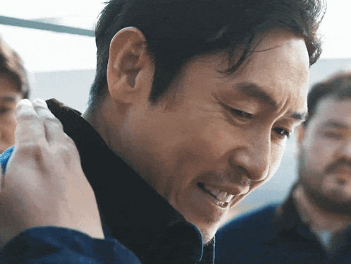 a close up of a man 's face with a smile