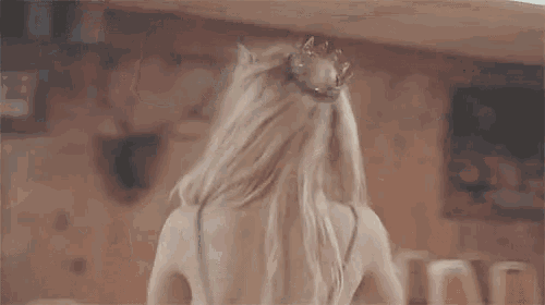 a woman with a tiara on her head is dancing