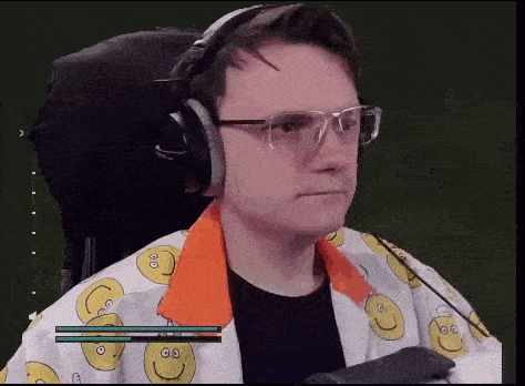 a man wearing headphones and glasses is sitting in a chair with a microphone .