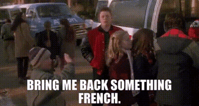 a man in a red jacket is shaking hands with a girl in a red jacket .