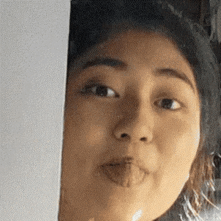 a woman is making a funny face with her tongue sticking out .