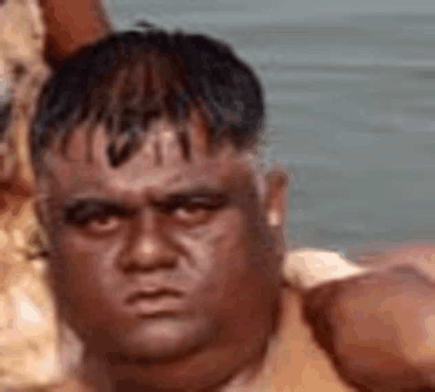 a close up of a man 's face with a serious look on it .