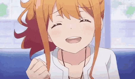 a close up of a girl with orange hair smiling .