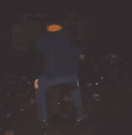 a person is standing in the dark with a light on their head .