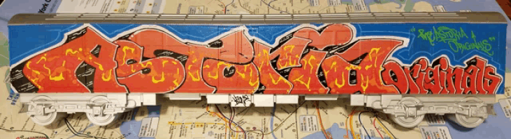 a model of a train with graffiti on it that says " almost a christmas "