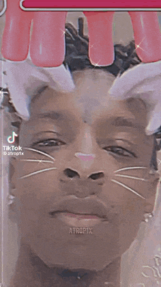 a close up of a person 's face with a cat face and a number 5 on their head .