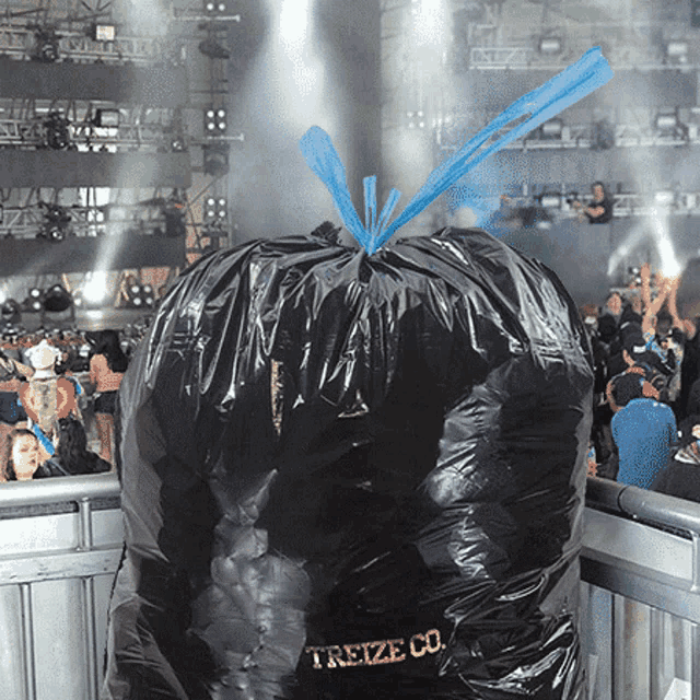 a large black trash bag with the word treize co. on it