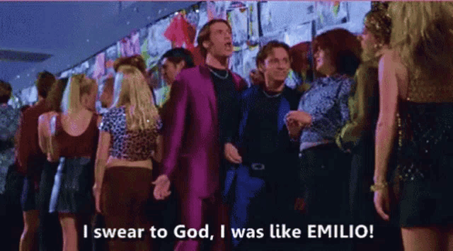 a man in a purple suit says i swear to god i was like emilio in front of a crowd of people