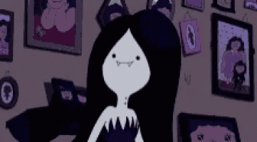 a cartoon character with long black hair is standing in a room surrounded by pictures .