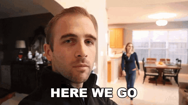 a man says here we go in front of a woman in a kitchen