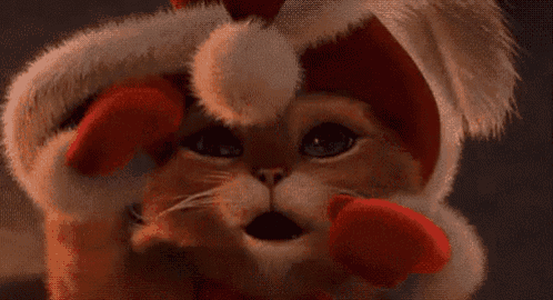 a cat wearing a santa hat and gloves is looking at the camera .
