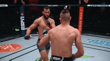 two men in a boxing ring with a sign that says espn on it