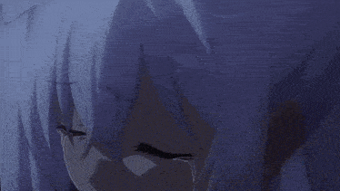 a boy is laying on a bed with a white blanket