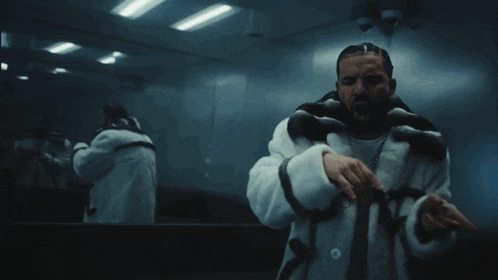 a man with a beard wearing a white fur coat stands in front of a mirror