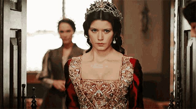 a woman wearing a tiara and a red dress