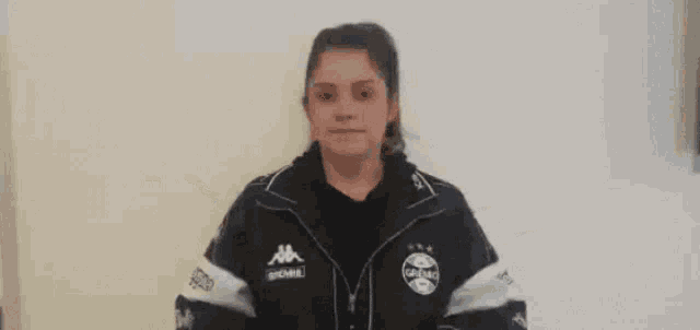 a girl wearing a jacket that says kappa on the front