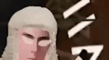 a close up of a person 's face with a white hat on their head .