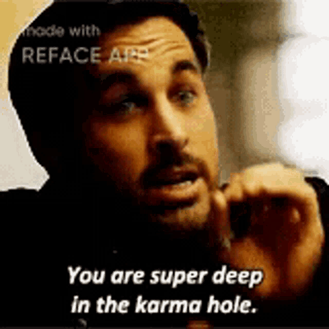a man with a beard is talking on a cell phone and saying `` you are super deep in the karma hole . ''