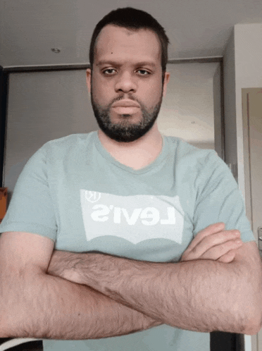 a man with a beard is wearing a levi 's t-shirt