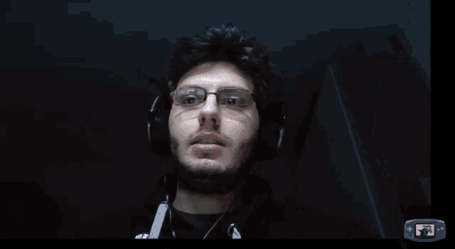 a computer screen showing a man wearing headphones