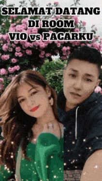 a man and a woman standing next to each other with flowers in the background
