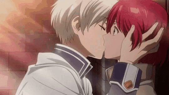 a man and a woman are kissing each other on the cheek