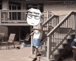 a man is standing on a set of stairs with a cartoon character on his head .
