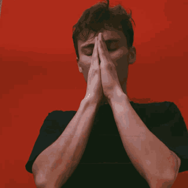 a man covering his face with his hands and the word azizinsan is above him
