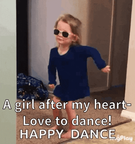 a little girl wearing sunglasses and a blue shirt is dancing