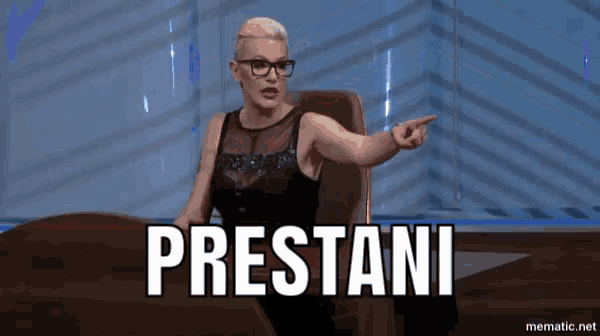 a woman sitting at a table with the word prestani on the screen